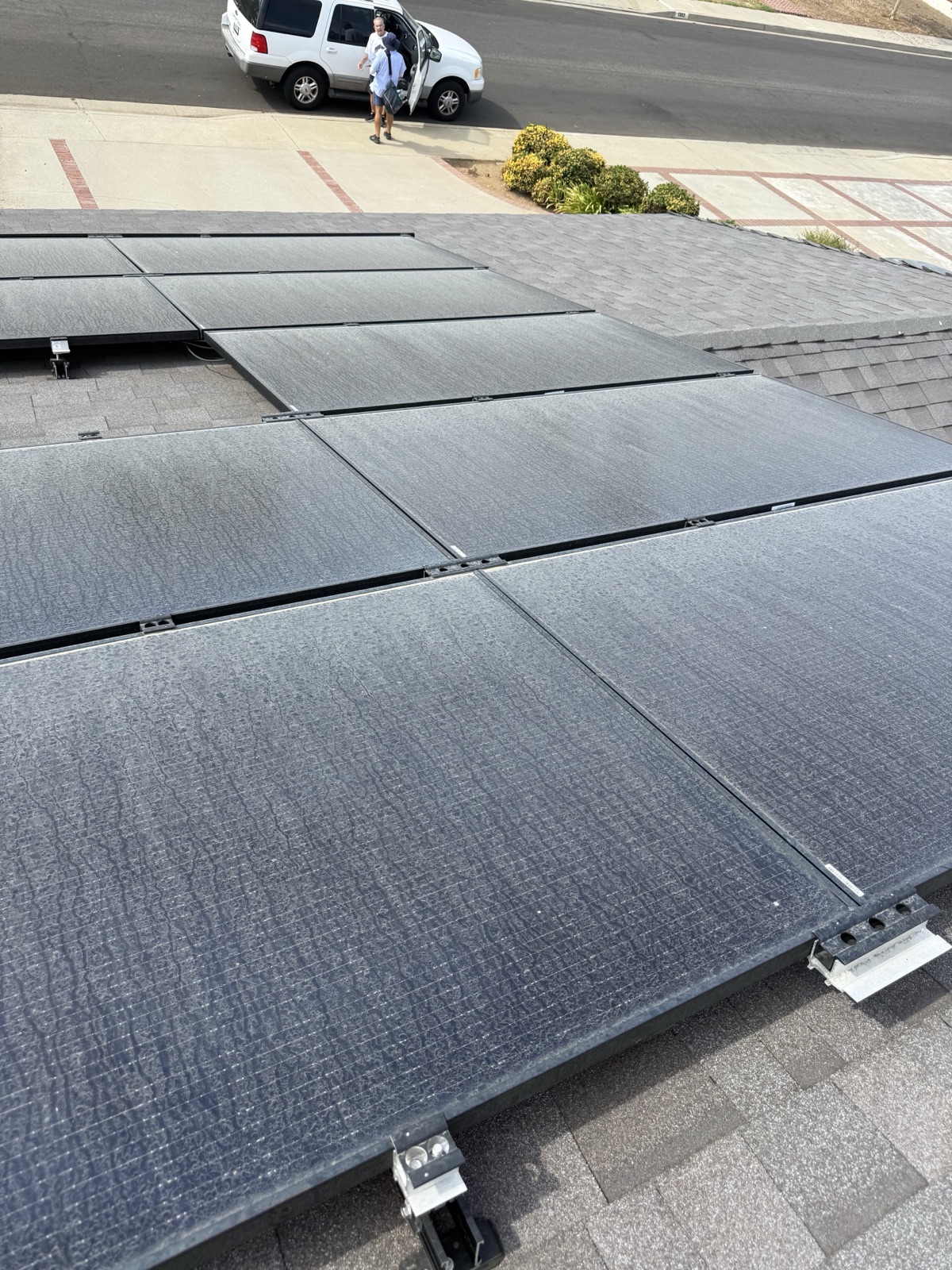 Close view of heavily soiled solar panels before cleaning